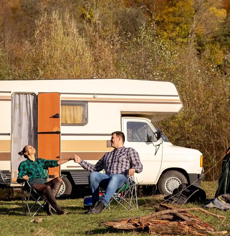 Couple relaxing outside their RV